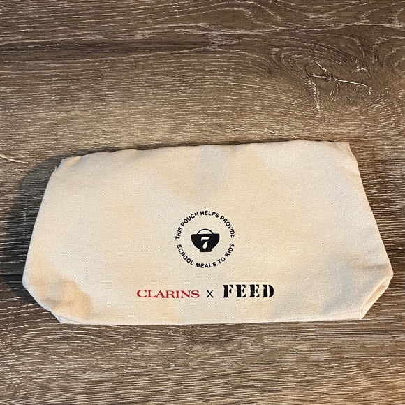 Clarins x FEED NWOT Cultivate Kindness Canvas Clutch with Red Accents 8.5x5.5 - Picture 2 of 5